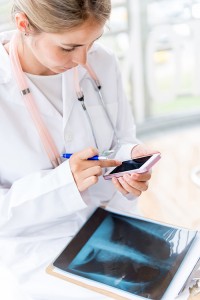 Doctor working at the hospital and using a smart phone