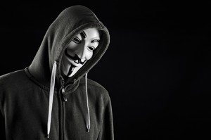 HILVERSUM, NETHERLANDS - MAY 20, 2013: Man wearing Vendetta mask, a well-known symbol for the online hacktivist group Anonymous. Also used by protesters. Editorial use only.
