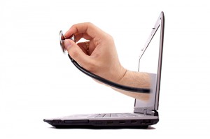 Male hand holding stethoscope emerges from a laptop screen.