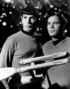 Leonard Nimoy and William Shatner post as Spock and Captain Kirk in a vintage black and white photo from the Star Trek series.