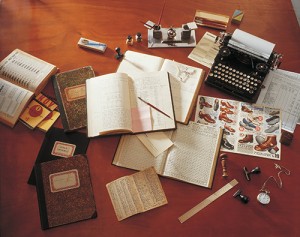 Vintage photo of books, journals, pens, and other tools of research circa 1930.