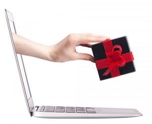 Hand emerging from laptop, holding wrapped gift.